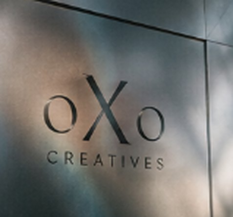 The oXo Creatives wordmark on a brushed silver panel